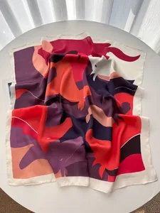 Close-up of vibrant abstract color block silk scarf with red and purple silk texture