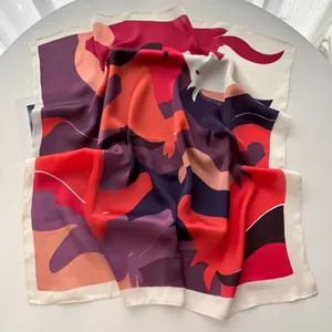 Detailed view of the abstract geometric pattern silk scarf with soft satin texture