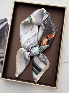 Nahaufnahme eines eleganten Seidenschals mit Schmetterlingsdruck in Geschenkbox