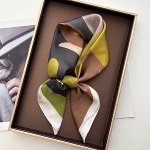 Silk-like square scarf featuring geometric color-block patterns and elegant satin luster