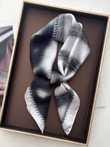 Macro detail of silk-like scarf featuring abstract black and white ink gradient texture