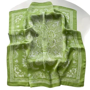 Grass green silk satin square scarf with white mandala floral prints on white backdrop
