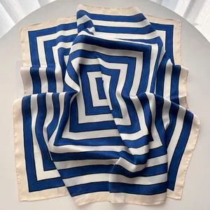 Detailed view of striped satin square scarf with geometric blue and white pattern