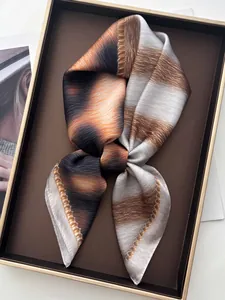 Detail of silk-like leopard print scarf in a luxury gift box with a beaded chain edge