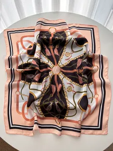 Detailed close-up of equestrian chain print silk scarf with fine rolled edge and label