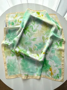 Detail of floral watercolor pattern and cream edge on lightweight silk square scarf