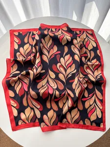 Detail of silk square scarf featuring retro leaf prints and red contrast edge