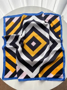 Close-up of silk-like square scarf with geometric diamond pattern and striped details