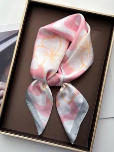 Silk-textured square scarf with floral print neatly folded in a premium gift box