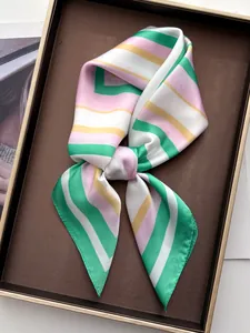Detail of colorful striped silk scarf folded in a brown tray with elegant texture