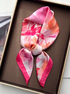 Detailed close-up of watercolor floral silk scarf with pink peony print and rolled hem