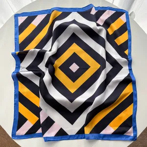Detail view of square silk scarf with geometric stripe patterns and bold color blocking