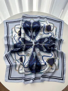 Detail of silk square scarf featuring nautical chain patterns and elegant tassel prints