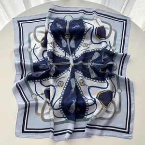 Macro shot of silk square scarf featuring nautical chain prints and tassel details