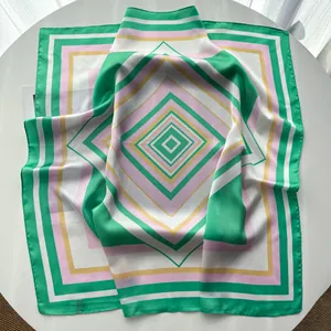 Detail of geometric diamond pattern silk scarf with colorful print and smooth texture