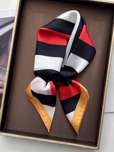 Detail of colorful striped silk scarf tied in a bow on a luxury display tray
