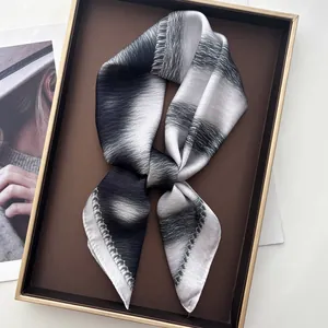 Elegant leopard print silk scarf with black and white texture on luxury display tray