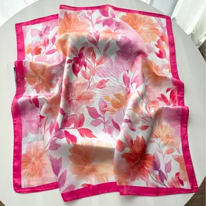 Close-up of watercolor peony floral print on silk scarf with pink satin hem