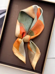 Detail of silk-like scarf with abstract mountain print and fine rolled edges