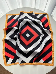 Detailed close-up showing the smooth silk-like texture and geometric stripe patterns on the scarf