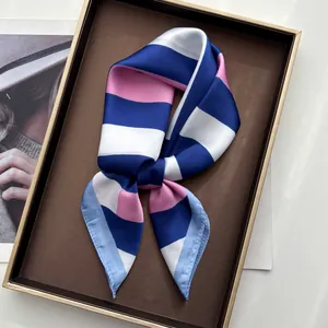 Close-up of blue, pink and white striped silk scarf tied in a bow on a display tray