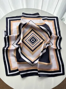 Detailed close-up of geometric striped silk scarf with elegant nested diamond patterns