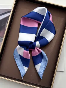 Macro detail of the elegant striped silk scarf with premium satin finish and hemmed edges