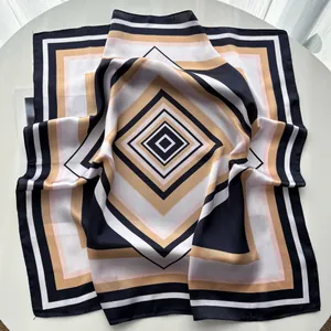 Close-up of geometric striped silk square scarf with satin finish and elegant folds