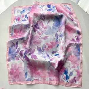 Close-up of pink and blue watercolor floral print on a silky satin square scarf fabric