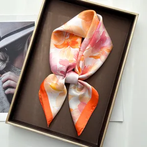 Detail of floral watercolor print silk scarf with vibrant orange peony patterns