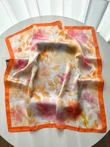 Close-up of silk square scarf with watercolor peony floral print and orange border