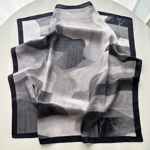 Macro shot of abstract mountain print on a silky square scarf with blue borders