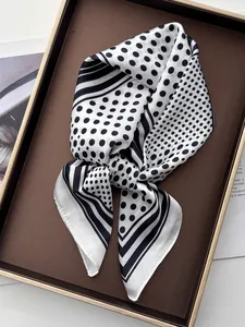 Detail of silk-like scarf with classic polka dots and border stripes on a tray