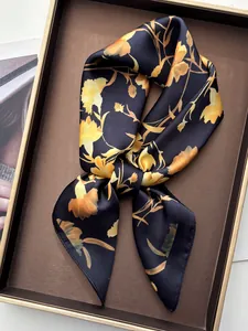 Elegant carnation floral silk scarf with yellow flowers on black background in tray