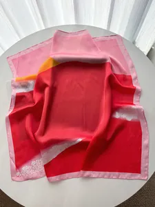 Detail view of smooth satin scarf texture with elegant floral prints and draping
