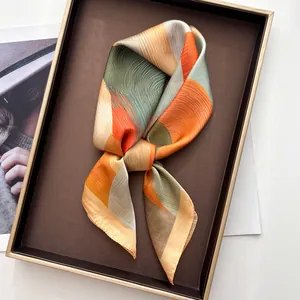 Elegant satin scarf with abstract mountain prints and geometric orange and green patterns