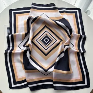Striped color-block square silk scarf with geometric diamond pattern on a white table