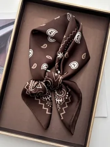 Close-up of brown paisley silk scarf showing soft texture and detailed geometric patterns