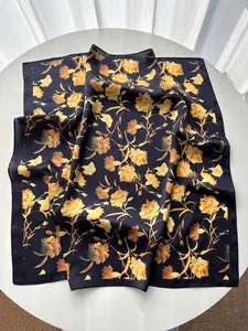Detailed pattern of elegant carnation flowers on silk-feel scarf with navy blue base