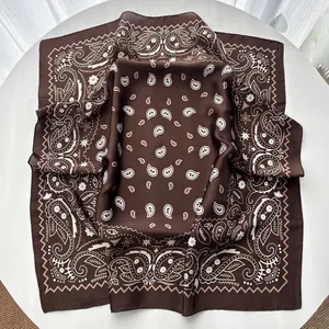 Macro detail of brown paisley silk scarf showing fine texture and vintage pattern