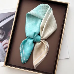 Polished mint green and champagne gold polka dot scarf detail on an elegant tray
