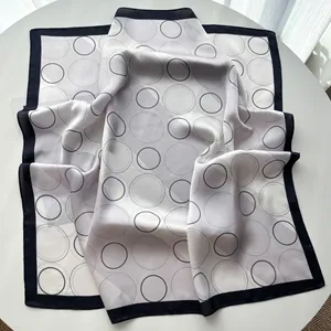 Detail of a square silk scarf with grey overlapping circles and black border