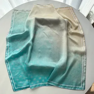 Detailed texture of gradient cyan silk scarf with polka dot and rhombus patterns