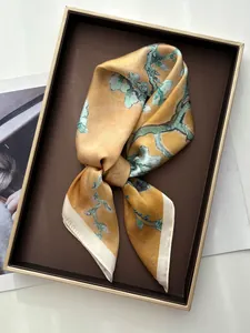 Close-up of plum blossom silk scarf with Van Gogh art print in a luxury gift box
