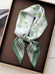 Close-up detail of French green floral and striped pattern on faux silk square scarf