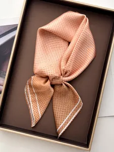 Close-up of silk-like satin scarf with brown polka dots and striped white borders