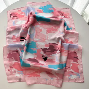 Detail of silk satin scarf with abstract floral patterns and rolled edge stitching