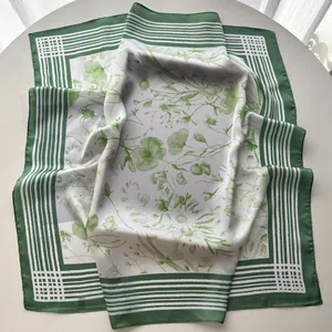 Close-up of green floral bouquet print on luxury striped square silk scarf