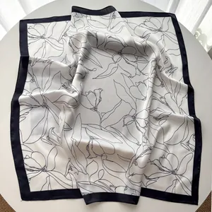 Detailed view of square silk scarf with vintage black floral print and satin finish