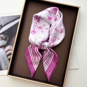 Close-up of luxury lilac floral silk scarf with striped borders in elegant gift box